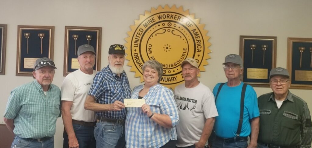 Members of the UMWA Local 6363 Board present a $500 check to United Way of Eastern Utah. Shown, from left to right, are George Motte, Terry Anderson, Vince Christiansen, UWEU Executive Director Pam Boyd, Brad Cook, Joe Montoya and Richard Maryboy.